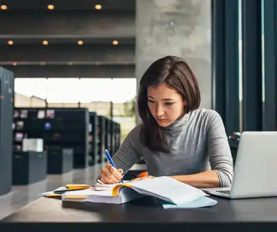 A female college student studying in a library.
