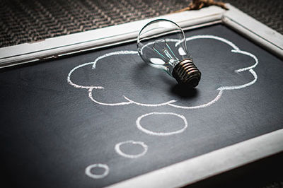 A lightbulb on a chalkboard