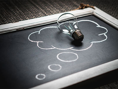 A lightbulb on a chalkboard